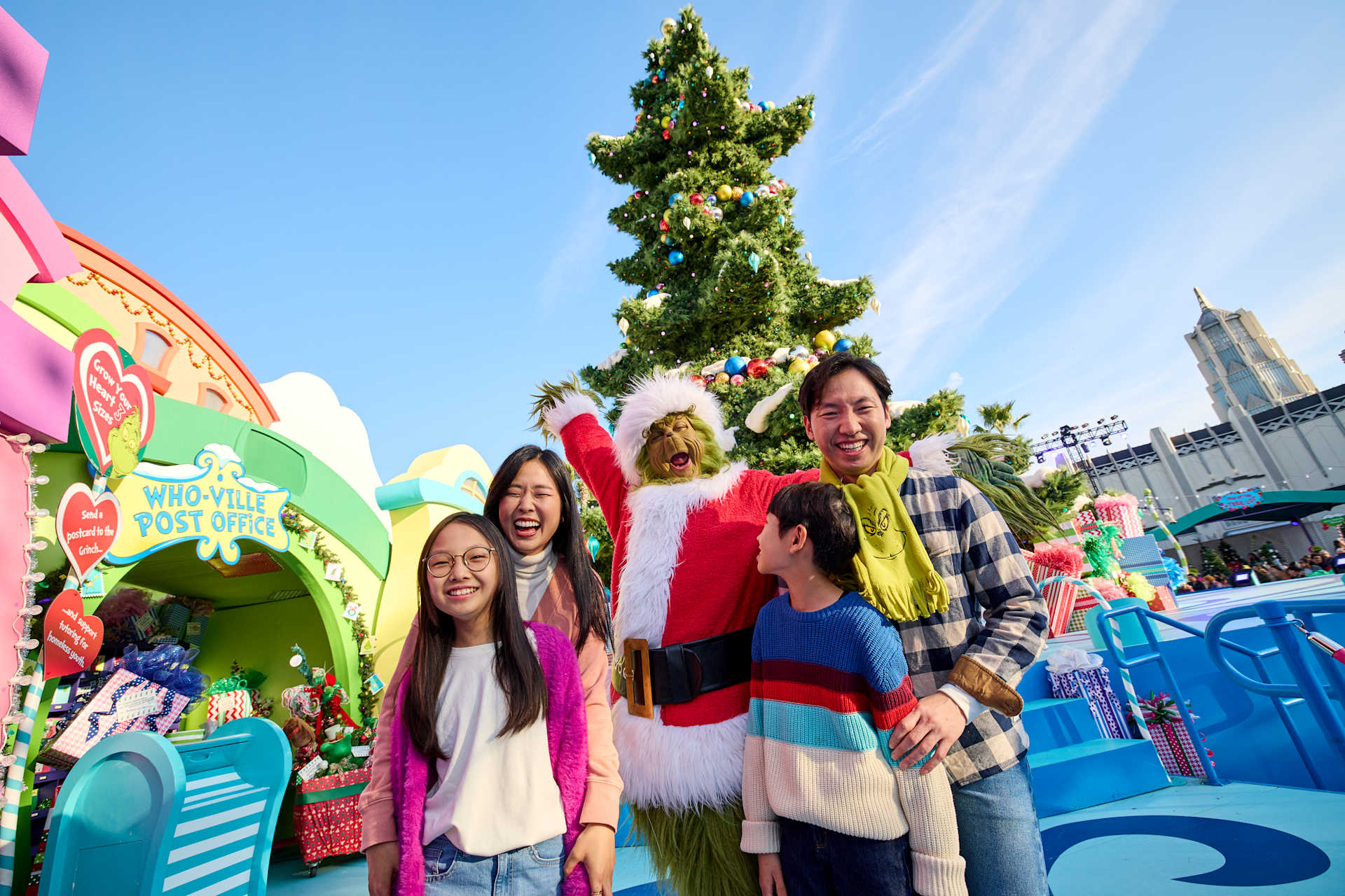 A family with the Grinch during Universal's Grinchmas period