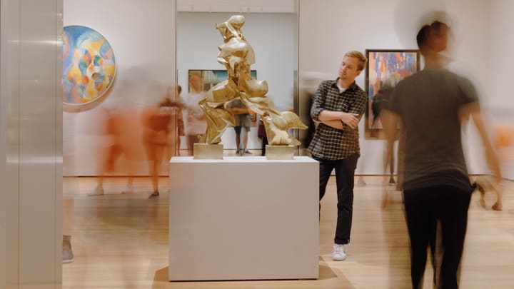 Tourists admiring a sculpture at the Museum of Modern Art (MoMA) in New York