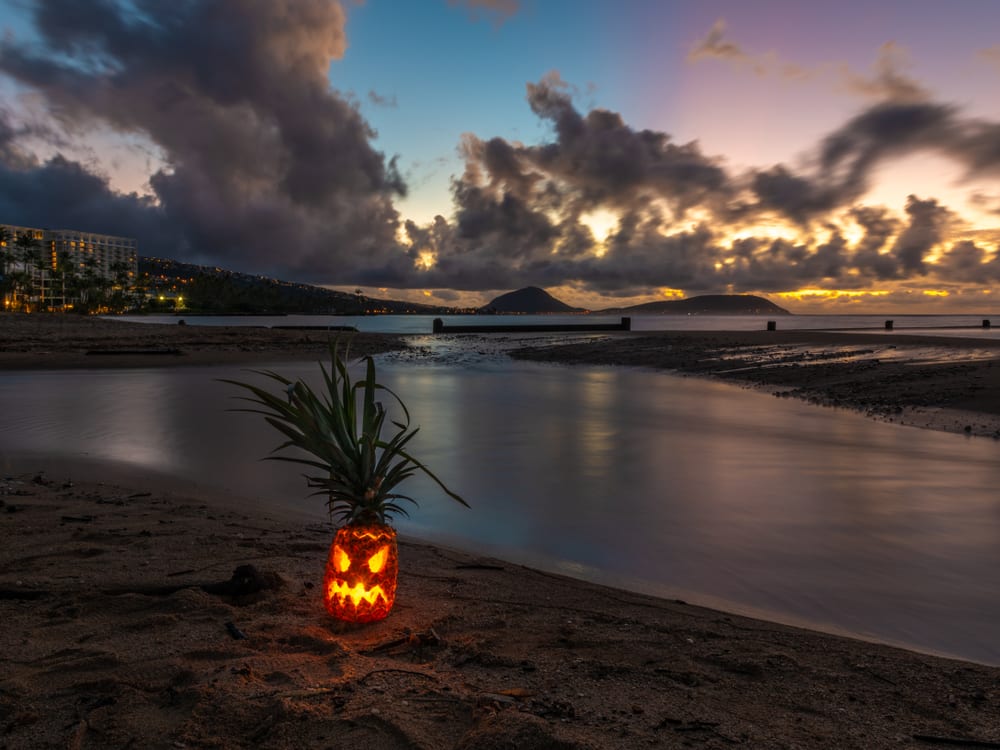 Scary Halloween pumpkin on the beach at dusk
