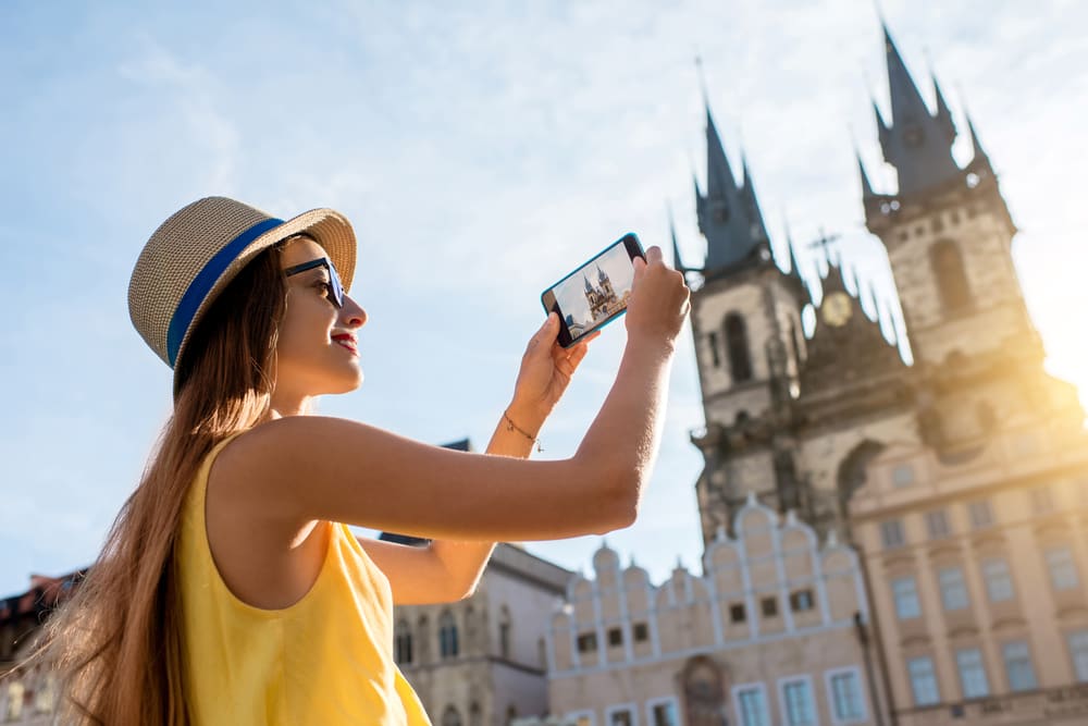 Tourist photographing the Church of Our Lady before Týn