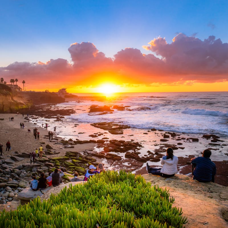 Tourists watching the sun set over La Jolla's beaches