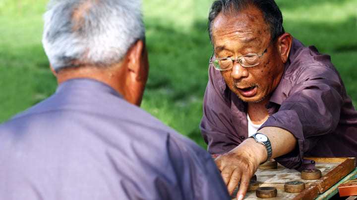 Men playing Chinese chess