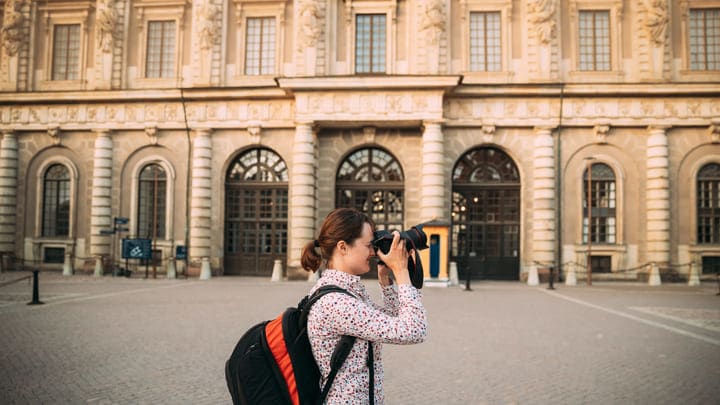 Tourist taking photos outside the Royal Palace in Stockholm