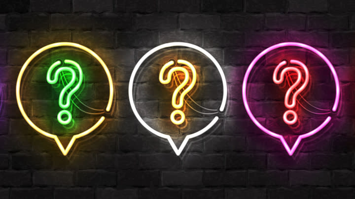Neon-light question marks and speech bubbles