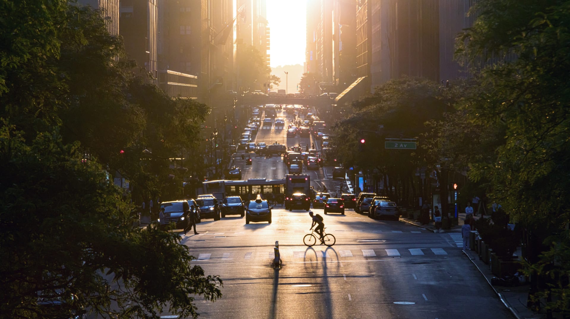 man-riding-bike-across-busy-intersection