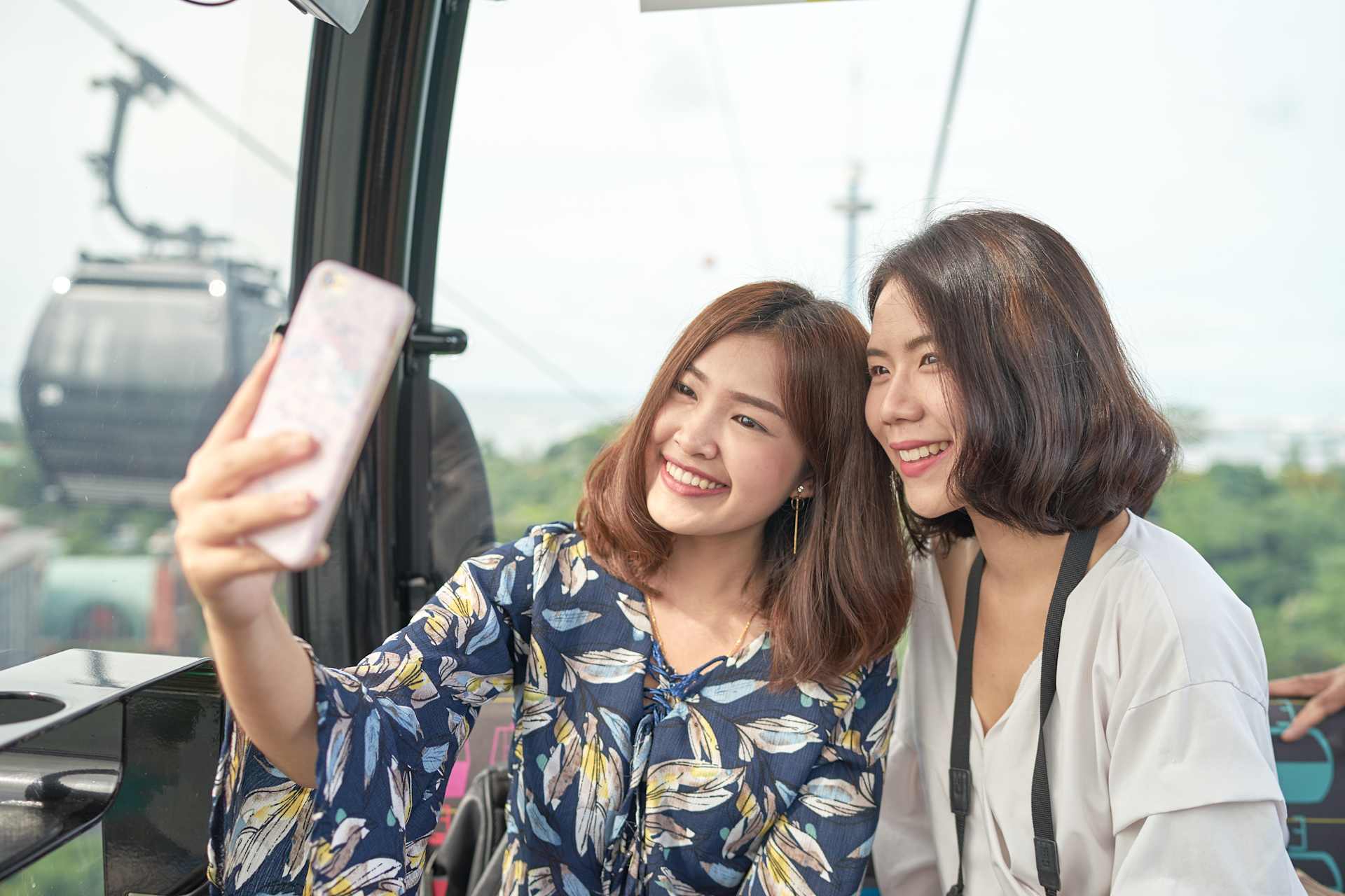 Mother and Daughter Taking a Selfie in a Cable Car