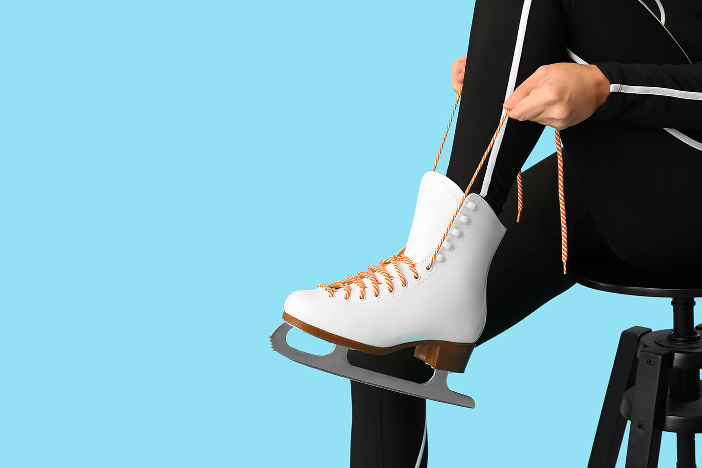 Eisläuferin zieht ihre Schlittschuhe an