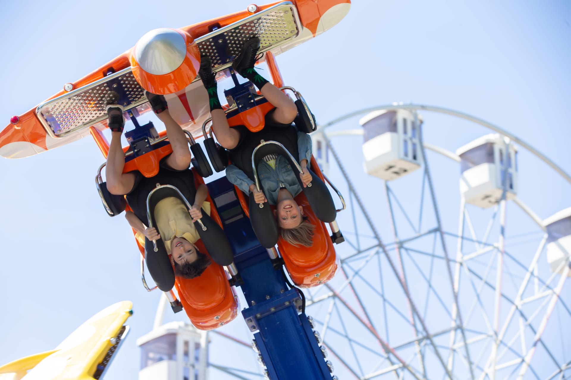 teenagers-ride-head-down-on-carousel