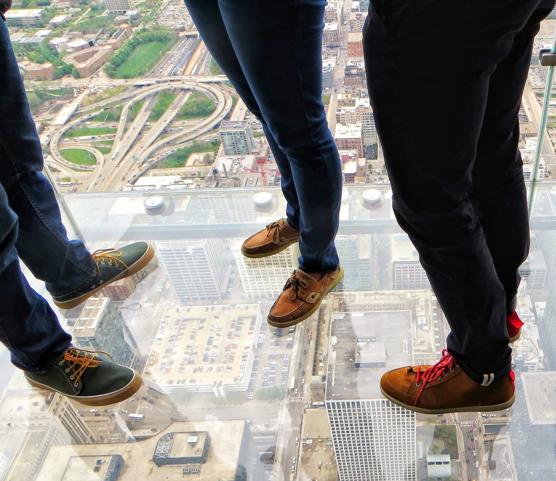 three-people-on-glass-skydeck-chicago