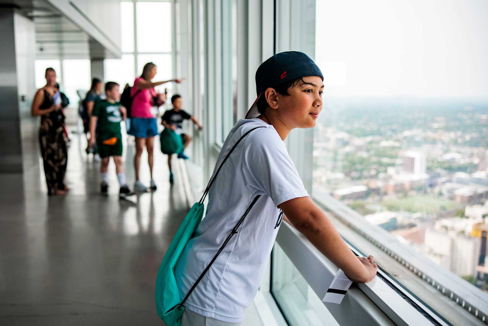 Boy Looking Out the Windows at View Boston