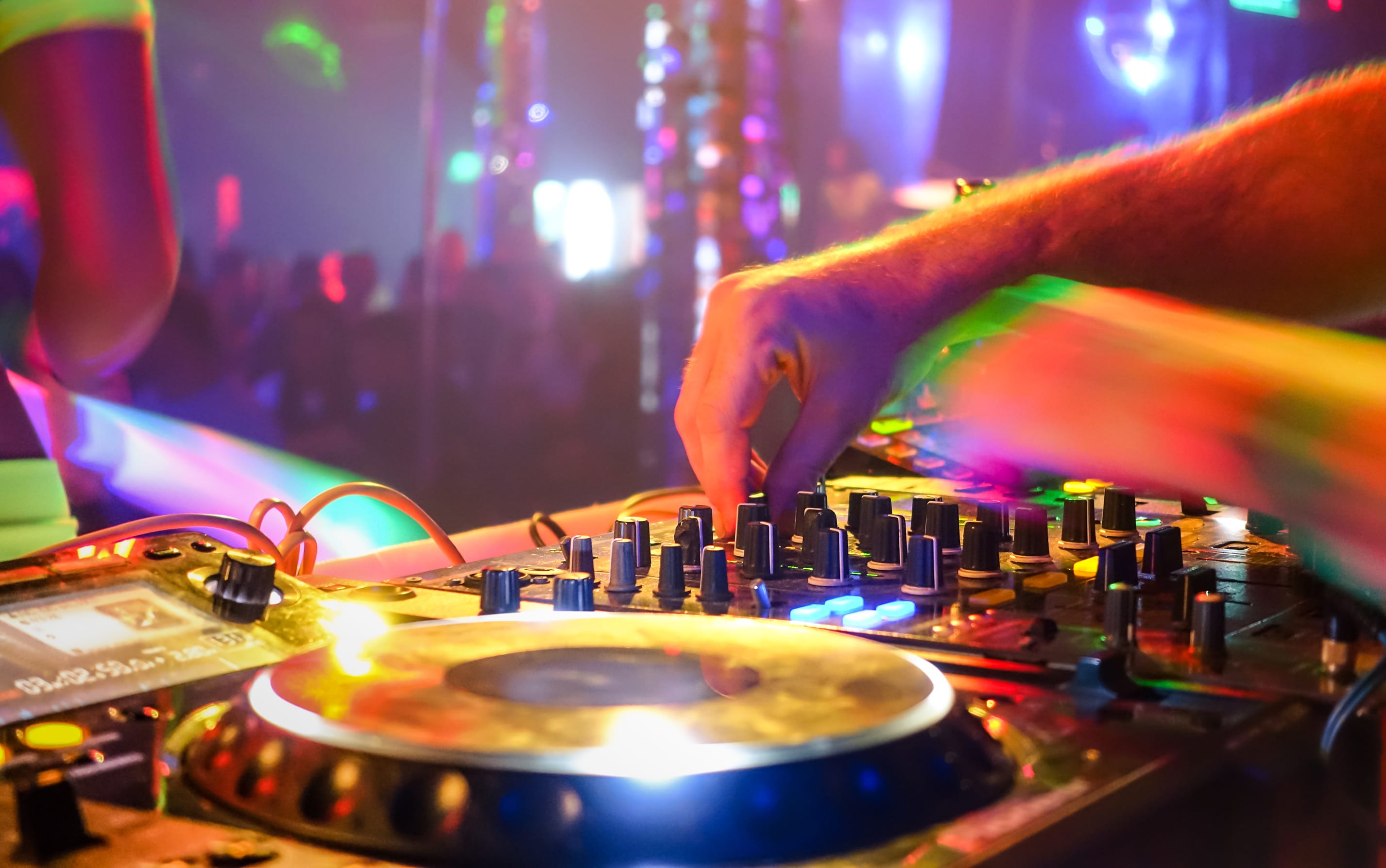 Closeup of a DJ spinning records in a nightclub