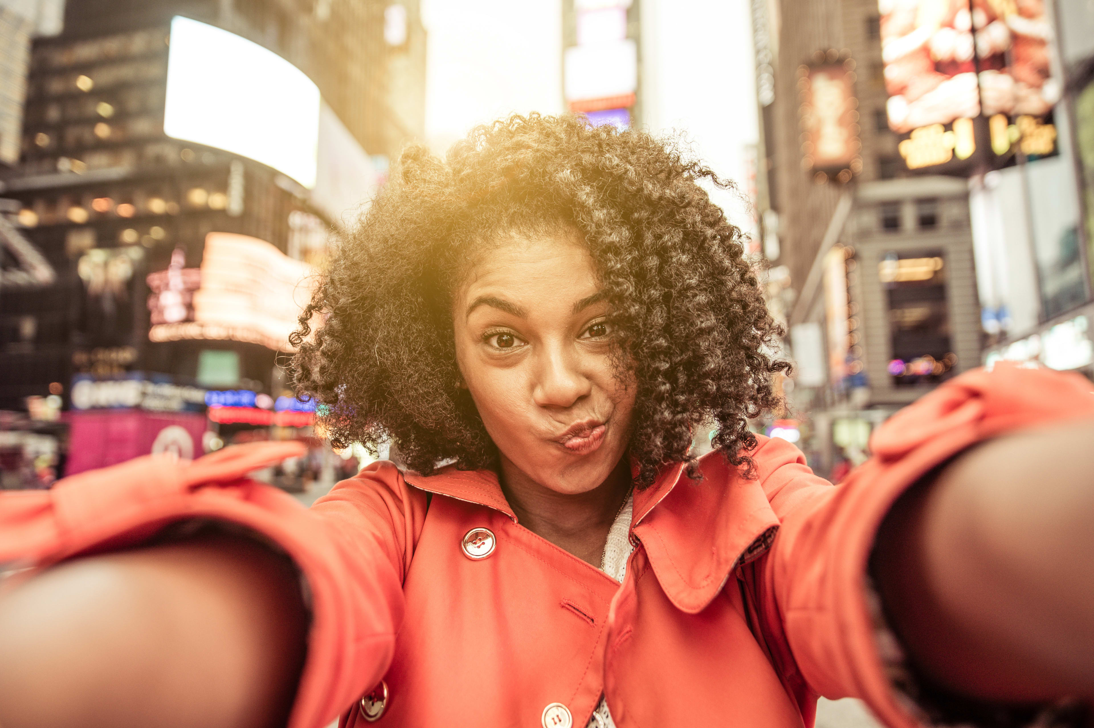 Woman taking selfie in Times Square, NYC