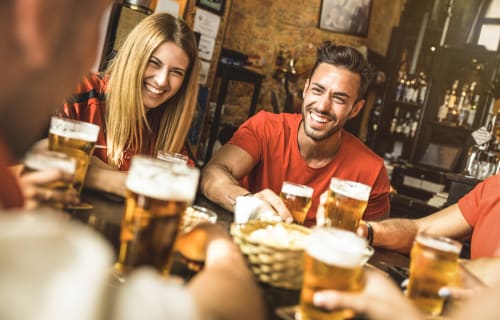 People sharing beers in a pub