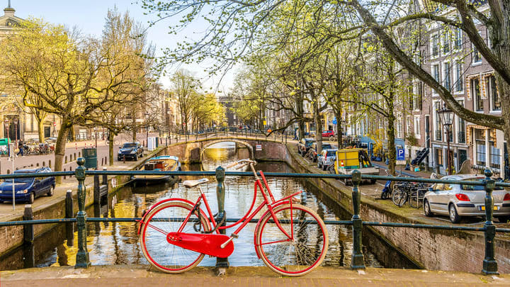 Bike parked next to an Amsterdam canal