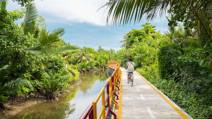 Cyclist on the elevated walkways at Bang Kachao, Bangkok