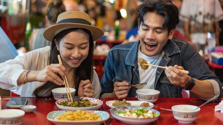 Young couple eating in Bangkok's Chinatown