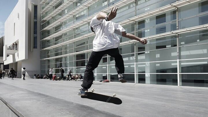 Skateboarder outside the minimalist MACBA building