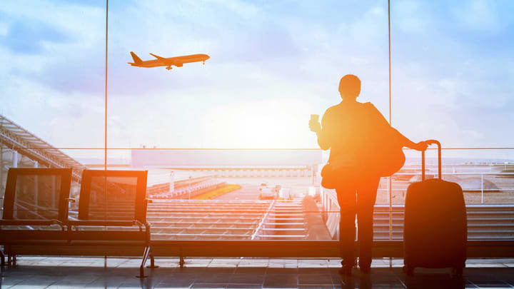 Traveler watching a plane taking off at the airport