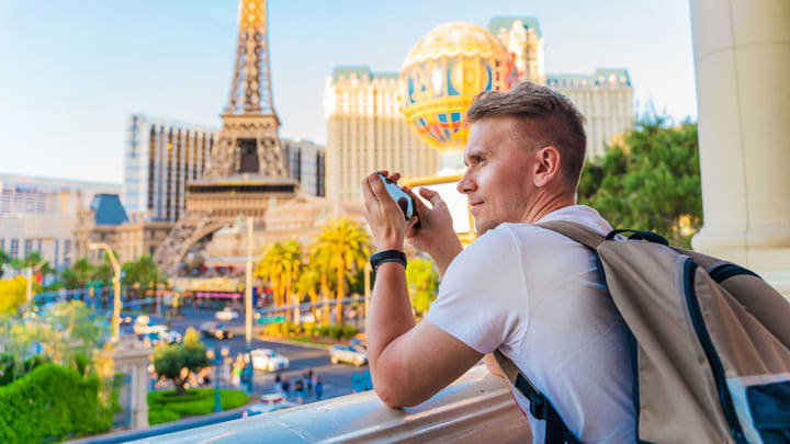 Tourist taking photos of the Paris resort's replica Eiffel Tower on the Las Vegas Strip