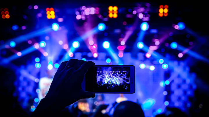 Concert-goer filming the show on a phone