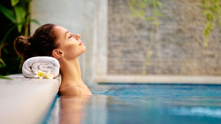 Woman relaxing in a pool at the spa