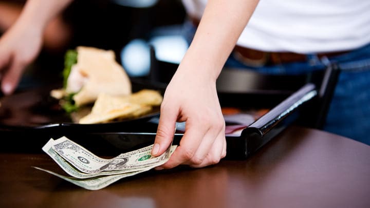 Restaurant worker accepting a cash tip