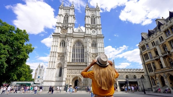 Woman gazing up at Westminster Abbey