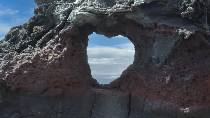 Heart-shaped natural rock formation at Nakelele Point.