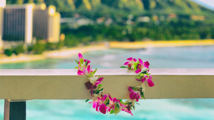 Traditional Polynesian lei garland hung on a balcony overlooking Waikiki Beach