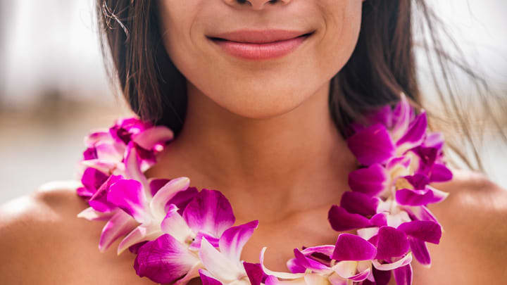 Woman wearing a traditional Polynesian floral lei.