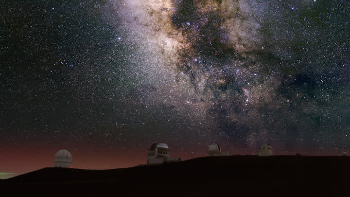 Telescope pods beneath the Milky Way at Mauna Kea, Hawaii