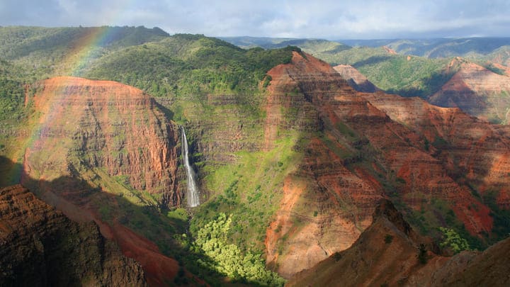 Rainbow over a waterfall in Waimea Canyon