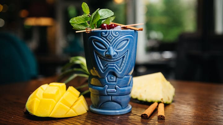 Tiki mug cocktail with mango and mint