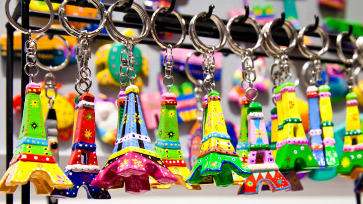 Store display of several colorful Eiffel Tower keyrings