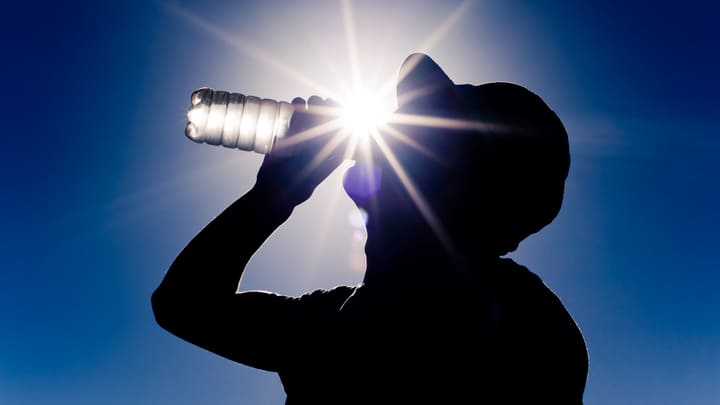 Man drinking water on a hot day