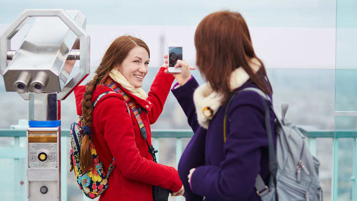 Friends taking photos on top of the Montparnasse Tower