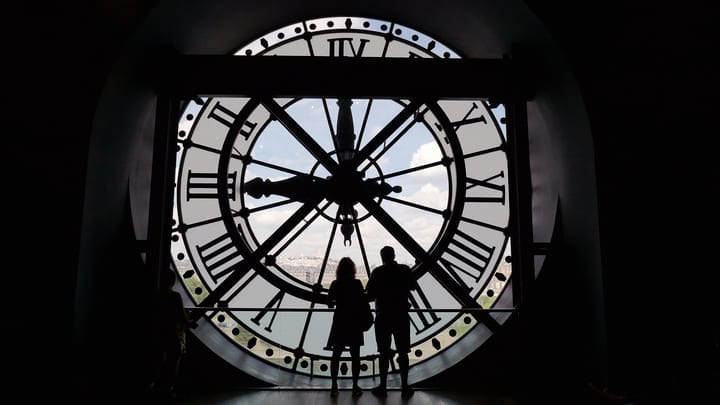 Couple silhouetted against the café closk at Musée d'Orsay