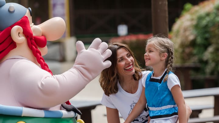 Child meeting Obelix at Parc Astérix near Paris