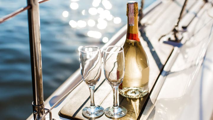 Bottle of bubbly and two glasses on a boat