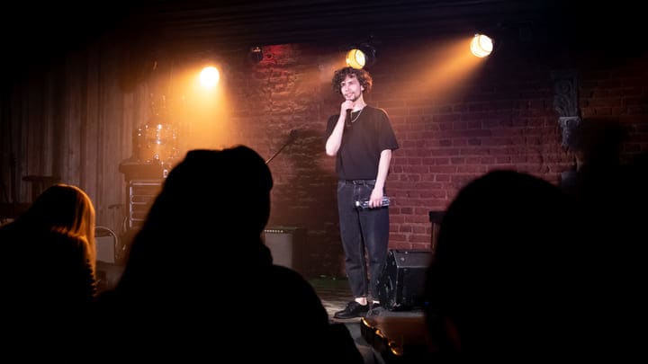 Young comedian performing at an open mic night