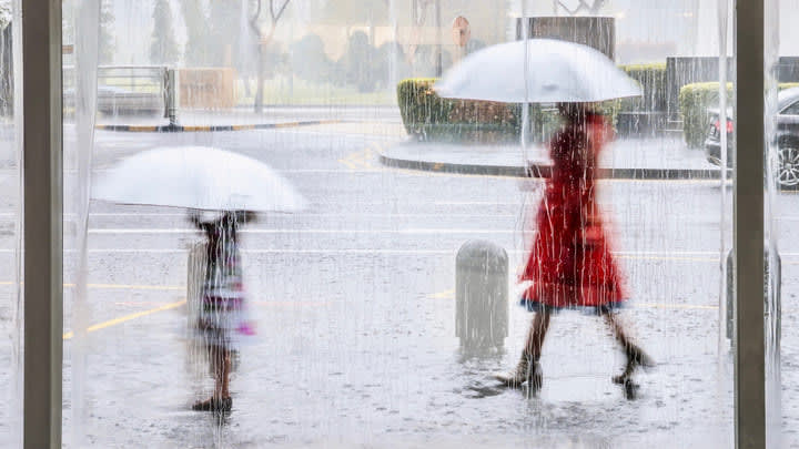 Parent and child caught out in a Singapore monsoon