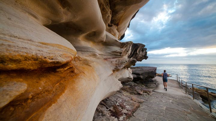 Jogger on a picturesque coastal walkway near Bondi Beach