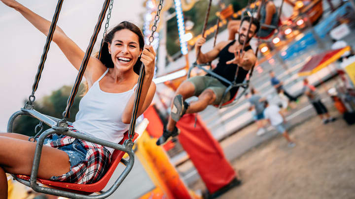 Man and woman on the swing ride at Luna Park in Sydney