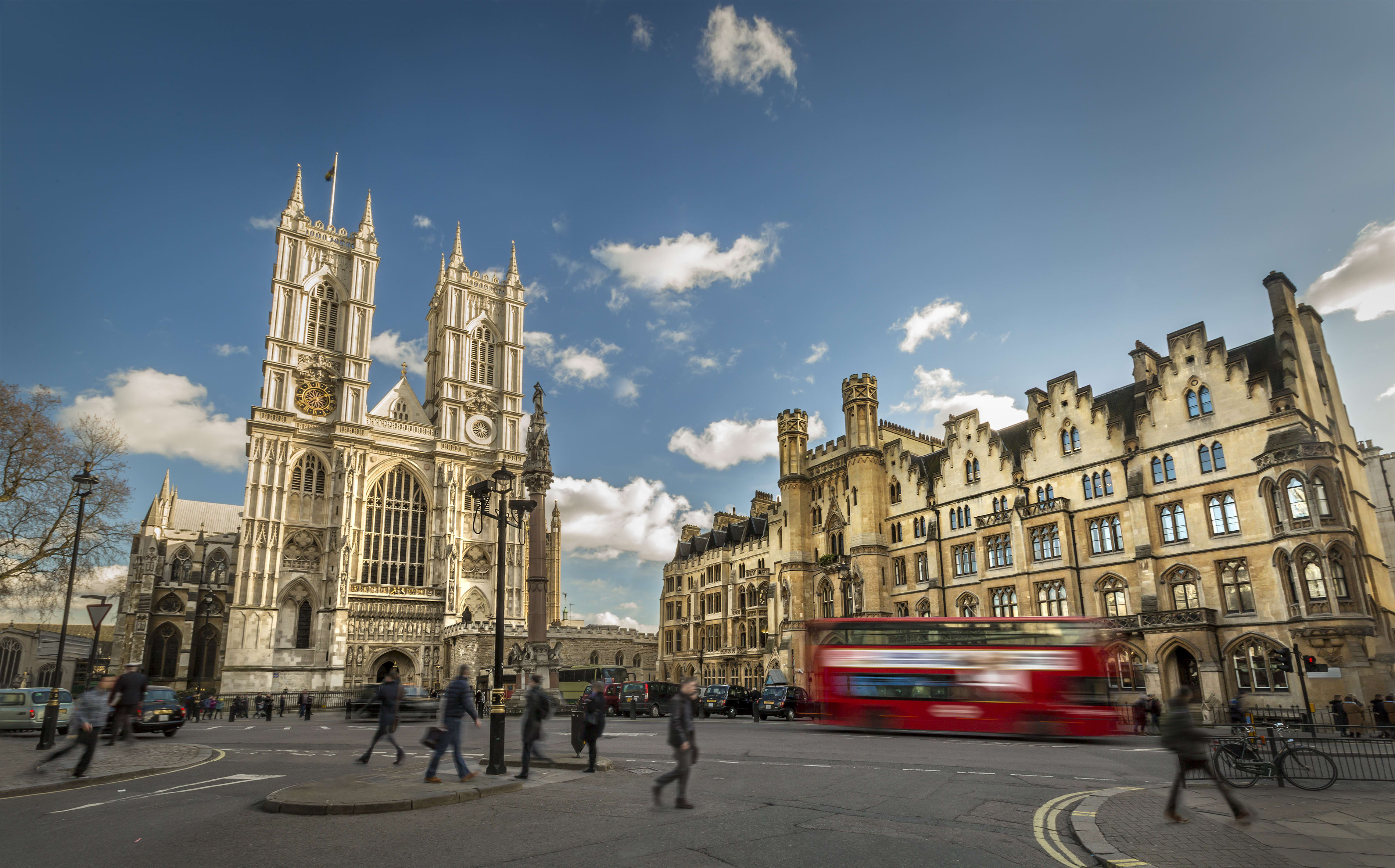 Westminster Abbey exterior with red London bus in foreground