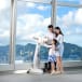 Family using a viewfinder at the Sky100 Hong Kong Observation Deck.