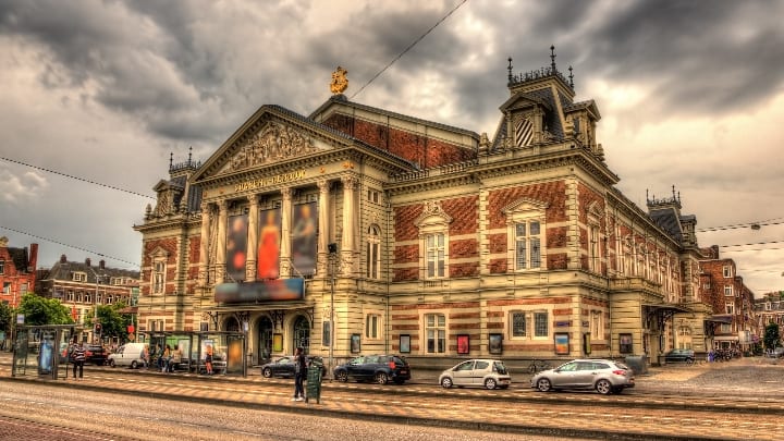 Image of City, Urban, Road, Street, Metropolis, Intersection, Car, Vehicle, Person, Terminal, Bicycle, Arch, Gothic Arch, 