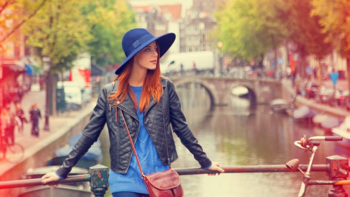 Image of Coat, Jacket, Hat, Face, Head, Person, Photography, Portrait, Pants, Baseball Cap, Cap, Blazer, Adult, Female, Woman, Sun Hat, Happy, Smile, City, Selfie, Accessories, Handbag,