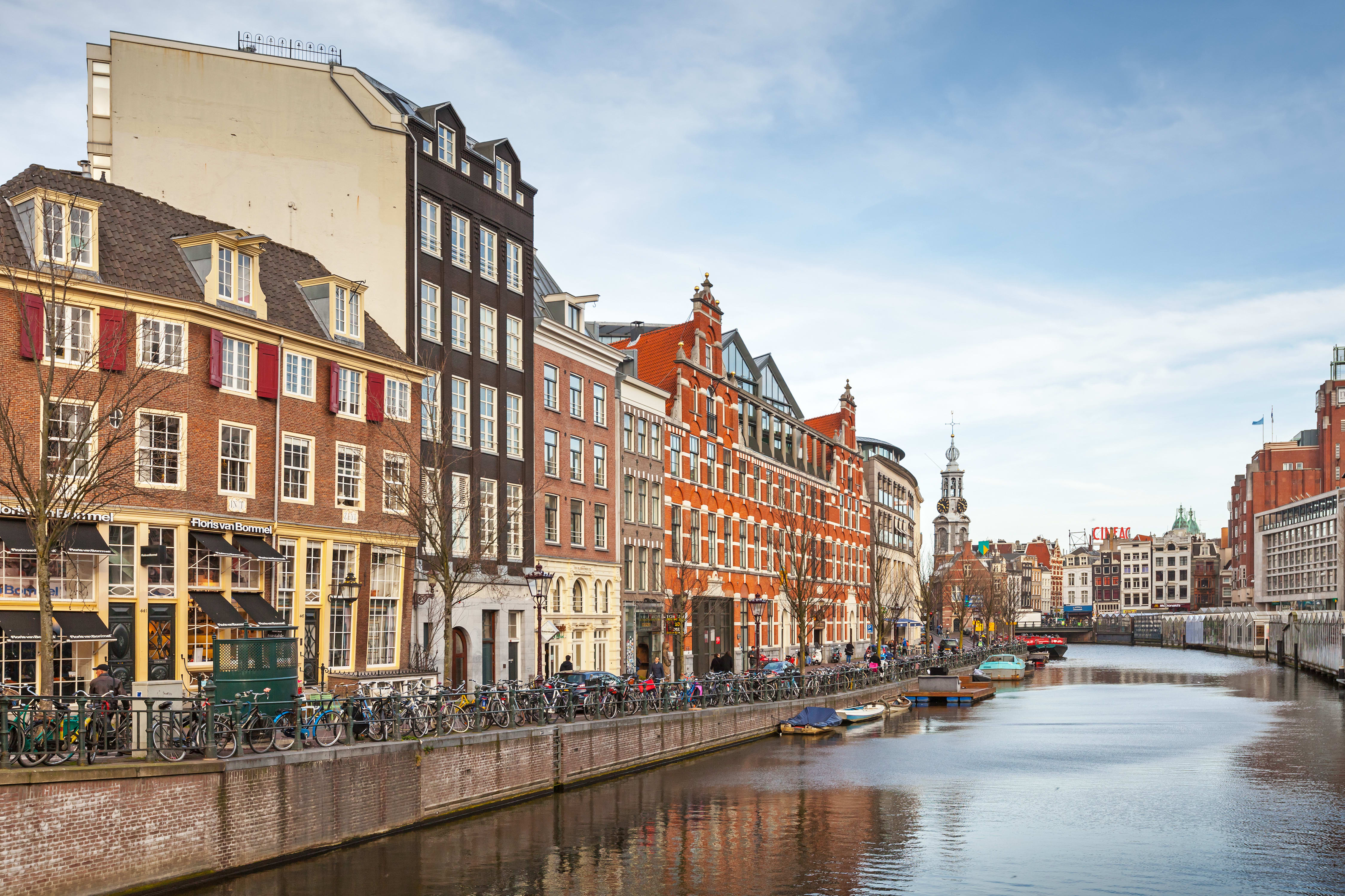 Image of Canal, Outdoors, Water, City, Metropolis, Urban, Waterfront, Neighborhood, Cityscape, Nature, Scenery, Boat, Vehicle, Bicycle, Person, 