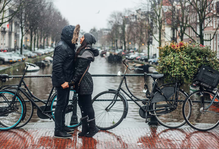 Image of Coat, Adult, Female, Person, Woman, Bicycle, Vehicle, Male, Man, Bag, Handbag, Head,