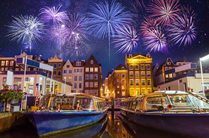 Image of City, Metropolis, Urban, Neighborhood, Water, Waterfront, Boat, Vehicle, Canal, Outdoors, Cityscape, Plant, Nature, Night, Fireworks, Yacht, 